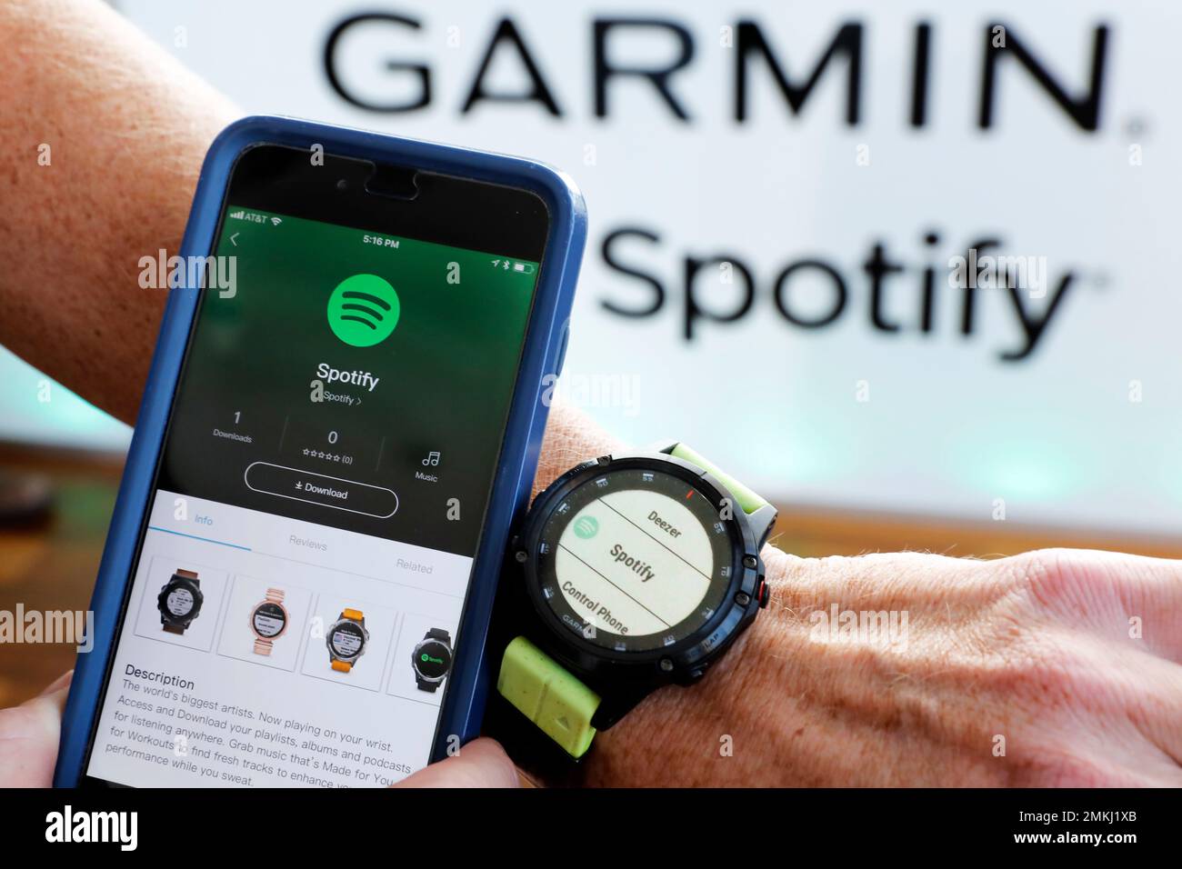 A Garmin International employee shows the new Spotify app on his smartphone  integrated with his Garmin fenix 5 Plus watch during a presentation, in New  York, Wednesday, Oct. 3, 2018. Garmin customers and Spotify Premium users  with a fenix 5 Plus ...