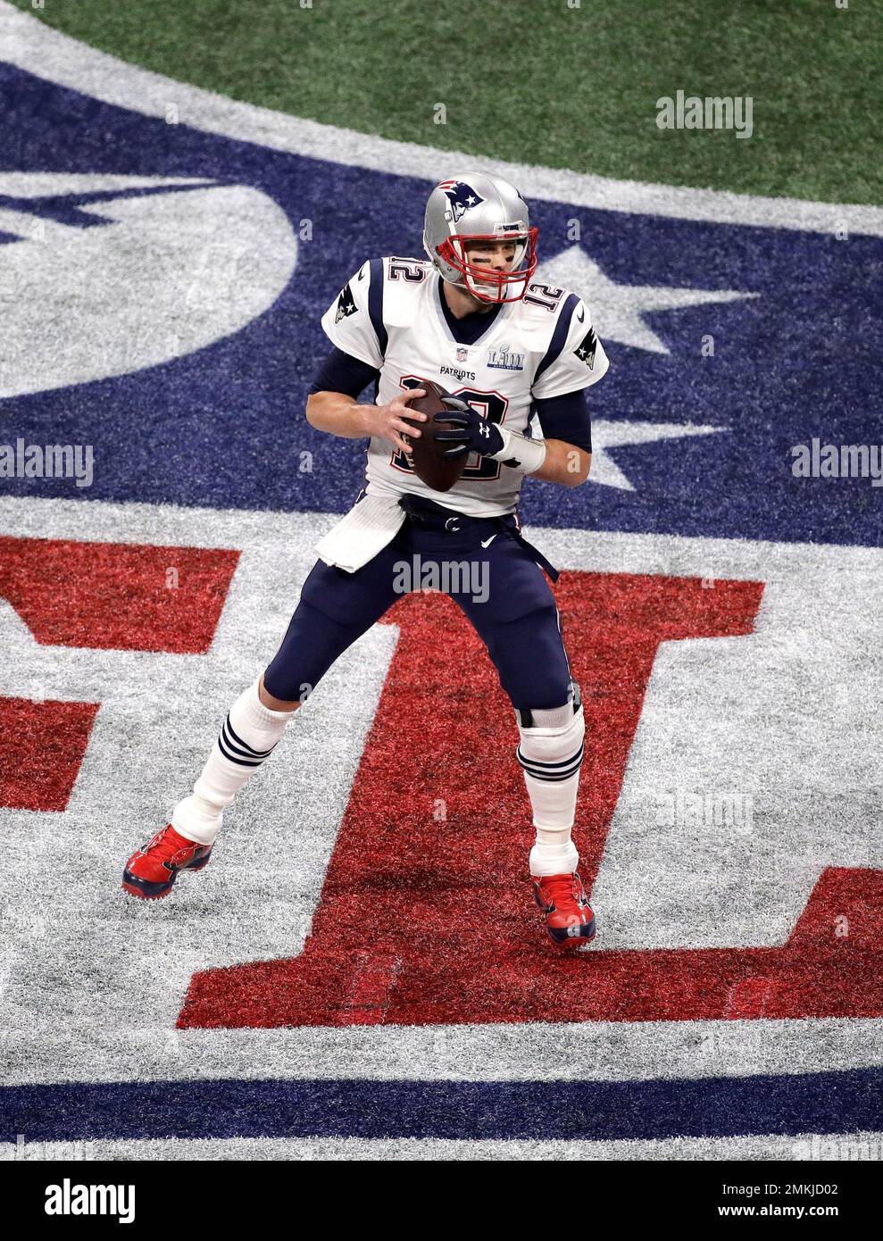 New England Patriots' Tom Brady (12) drops back to pass against