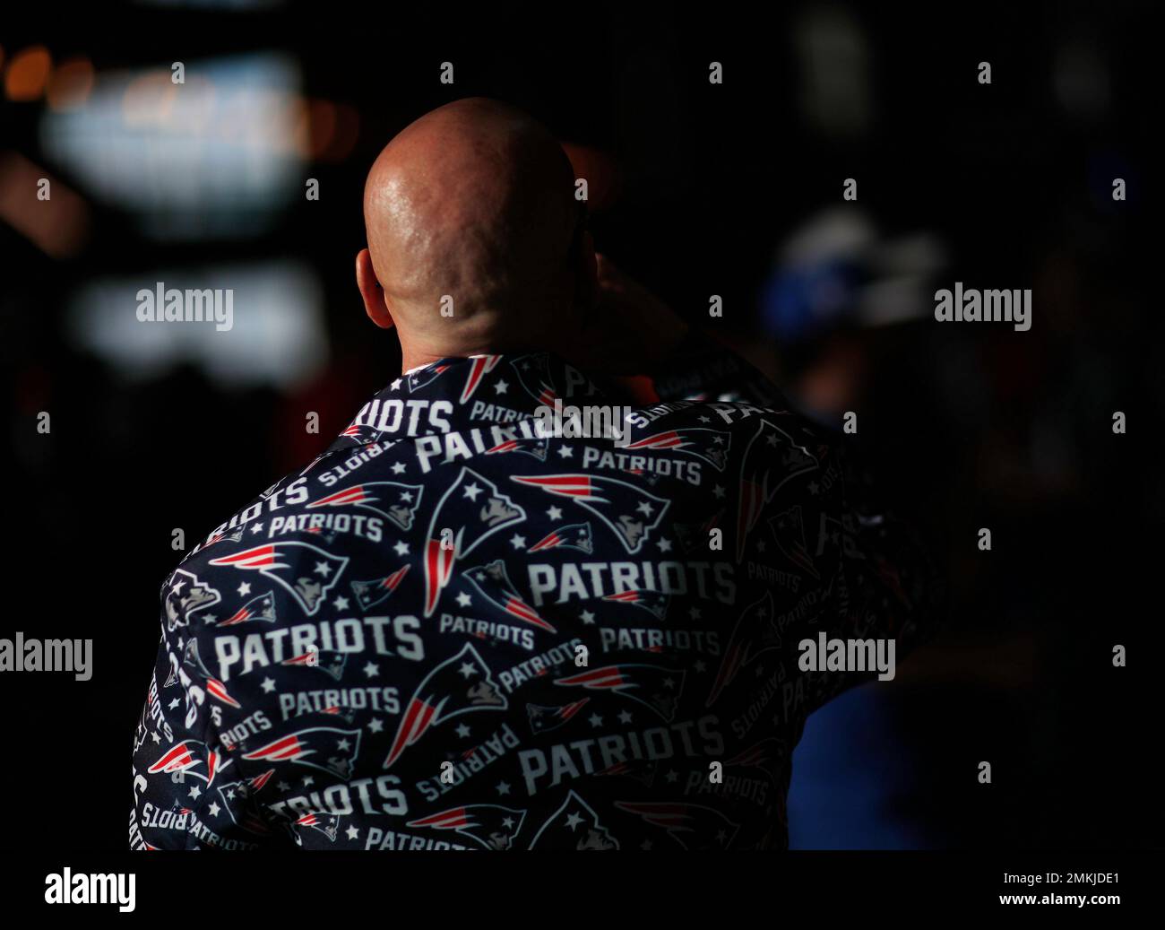 A fan walks by a giant helmet outside the New England Patriots Pro Shop  prior to an NFL football game, Sunday, Sept. 12, 2021, in Foxborough, Mass.  (AP Photo/Steven Senne Stock Photo 