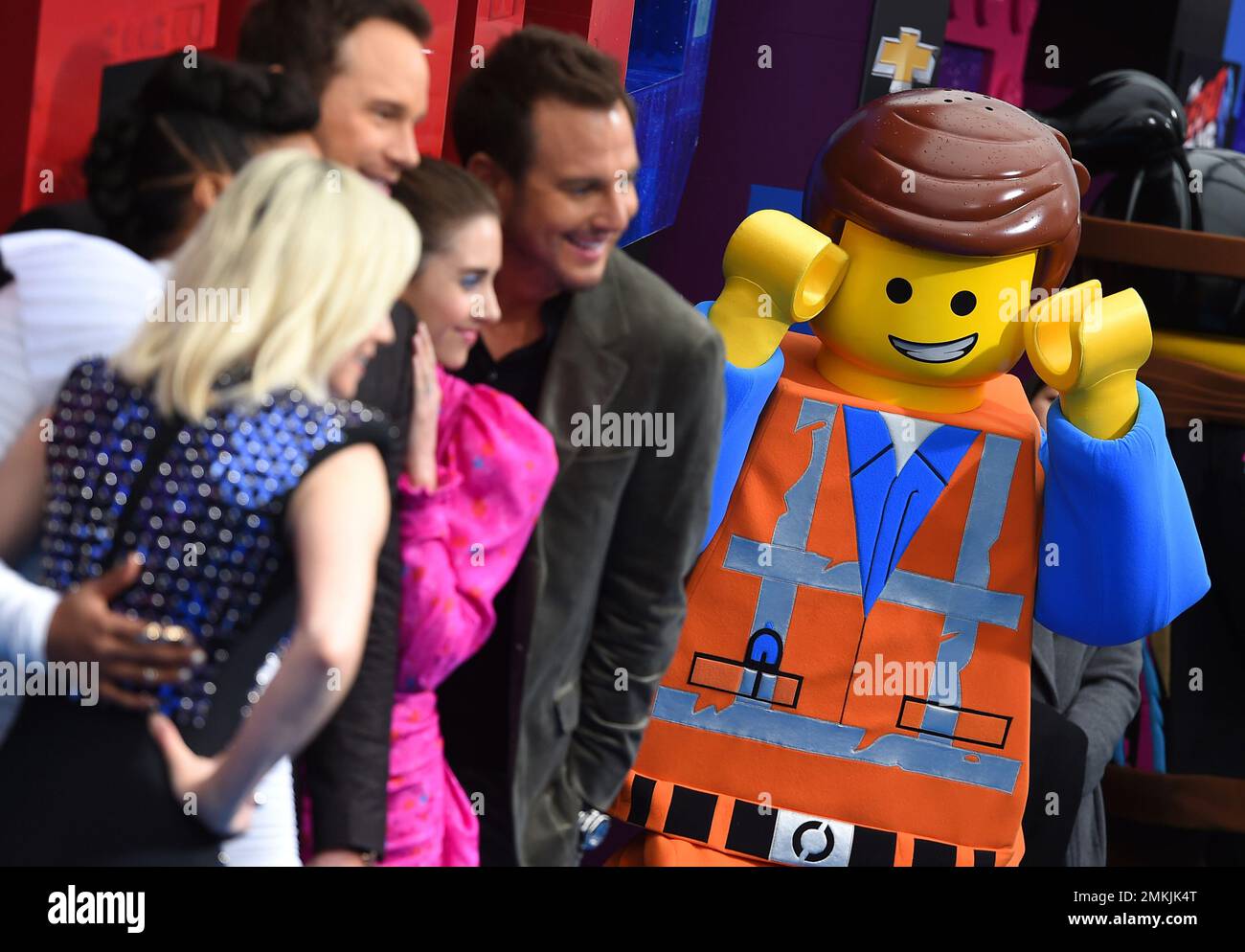 A costumed character from the movie reacts to cast pictures at the