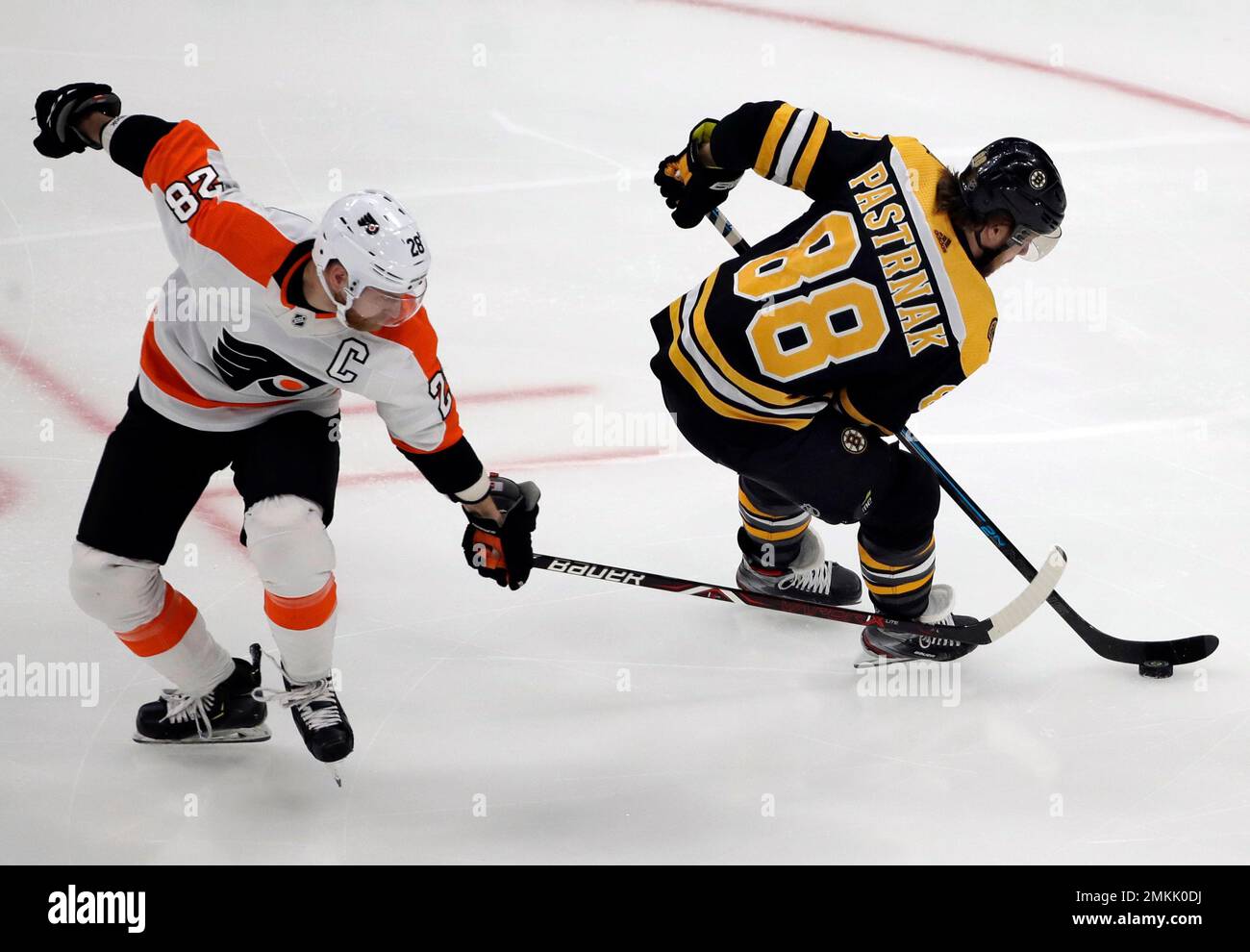 Boston Bruins right wing David Pastrnak (88) is tripped by Philadelphia