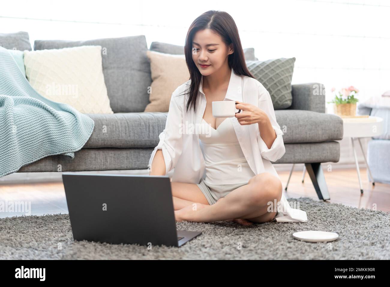 A young woman to use a computer at home Stock Photo - Alamy