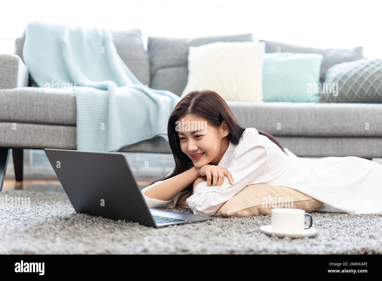 A young woman to use a computer at home Stock Photo - Alamy