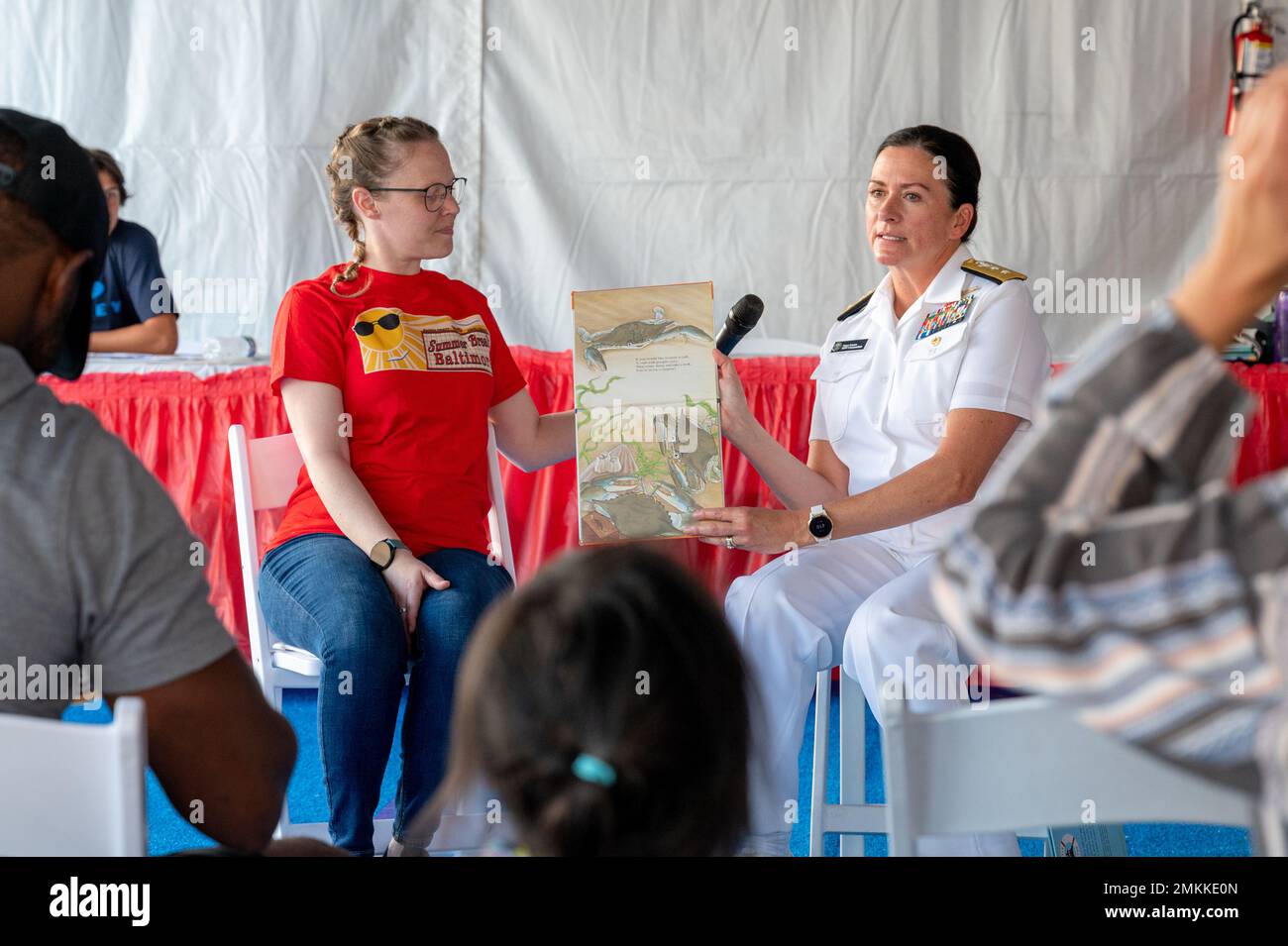 BALTIMORE (Sept. 10, 2022) Rear Adm. Nancy Lacore, Commandant, Naval District Washington, along with librarians of Enoch Pratt Free Library conduct a live reading of Boats Will Float to children attending Maryland Fleet Week and Flyover 2022. Maryland Fleet Week and Flyover is Baltimore’s celebration of the sea services and provides an opportunity for the citizens of Maryland and the city of Baltimore to meet Sailors, Marines and Coast Guardsmen, as well as see firsthand the latest capabilities of today’s maritime services. Stock Photo