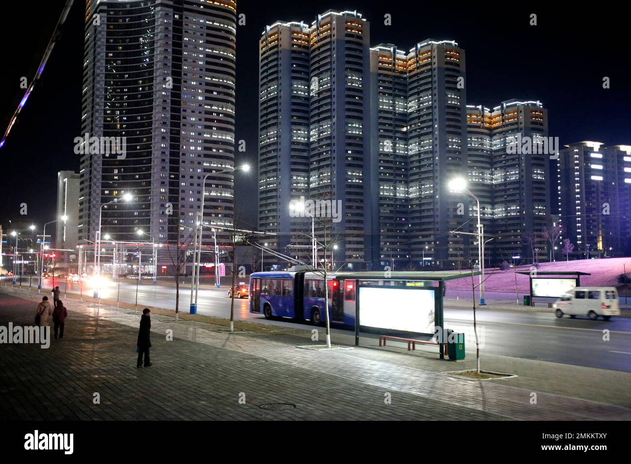 Lights from apartment building illuminate the night sky in downtown ...