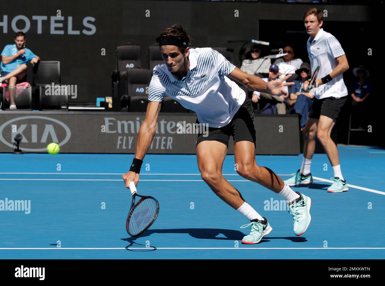 France's Pierre-Hugues Herbet, left, and compatriot Nicolas Mahut in action  during the men's doubles final against Finland's Henri Kontinen and  Australia's John Peers at the Australian Open tennis championships in  Melbourne, Australia,