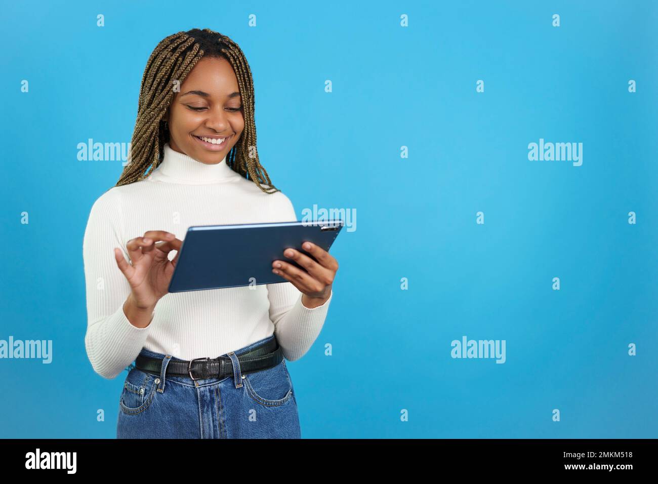 Smiling african woman using a digital tablet Stock Photo