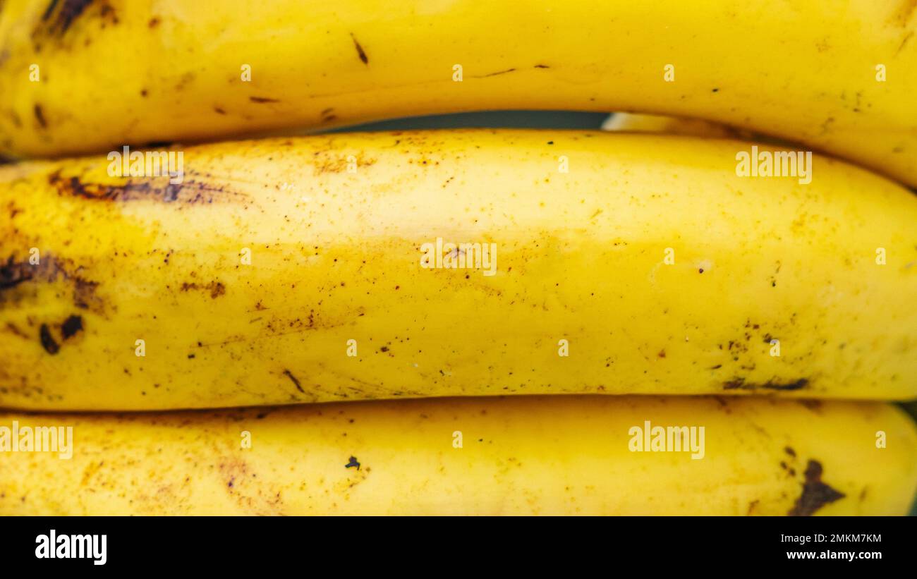 Close up ripe banana skin with brown spots Background peel texture macro photo. Tropical fruit