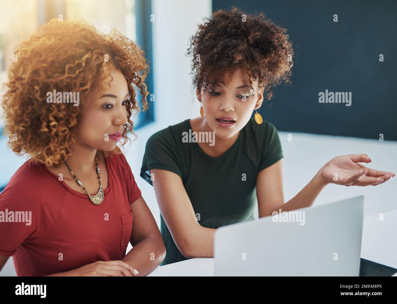 Theyve got the need to succeed. two young designers working on a laptop together. Stock Photo