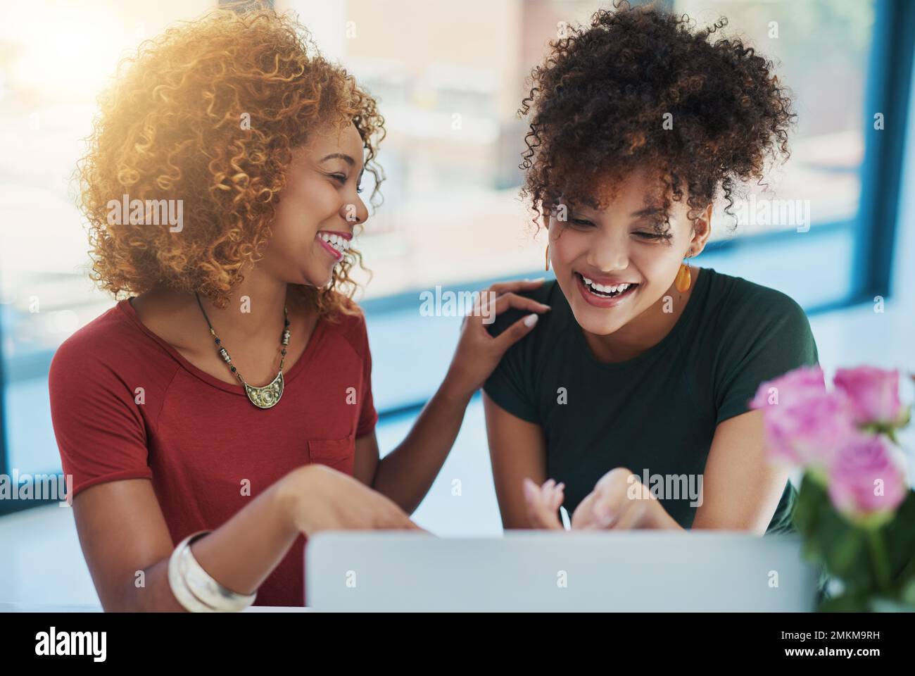 You totally nailed it. two young designers working on a laptop together. Stock Photo