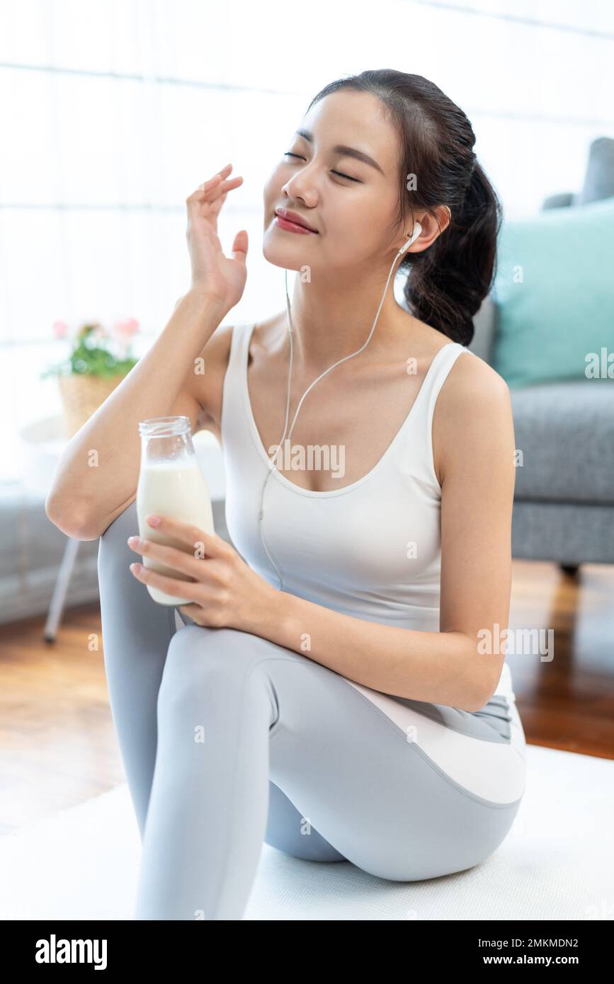 The young woman rest to drink milk after exercise Stock Photo Alamy