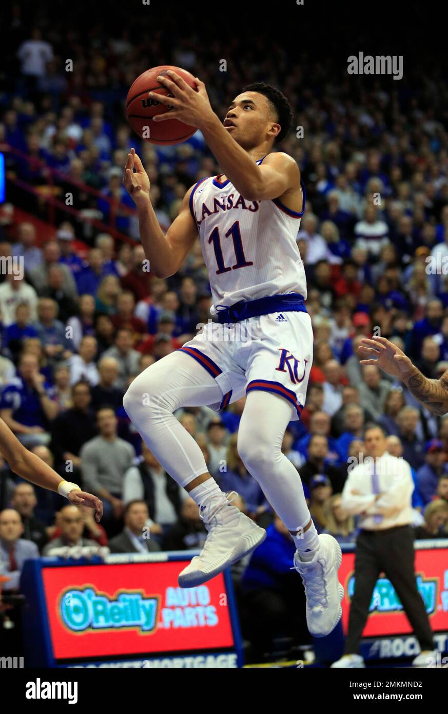 Auburn guard J'Von McCormick, right, goes to the basket as Kansas guard Devon  Dotson (11) defends during the second half of a second-round game in the  NCAA men's college basketball tournament Saturday