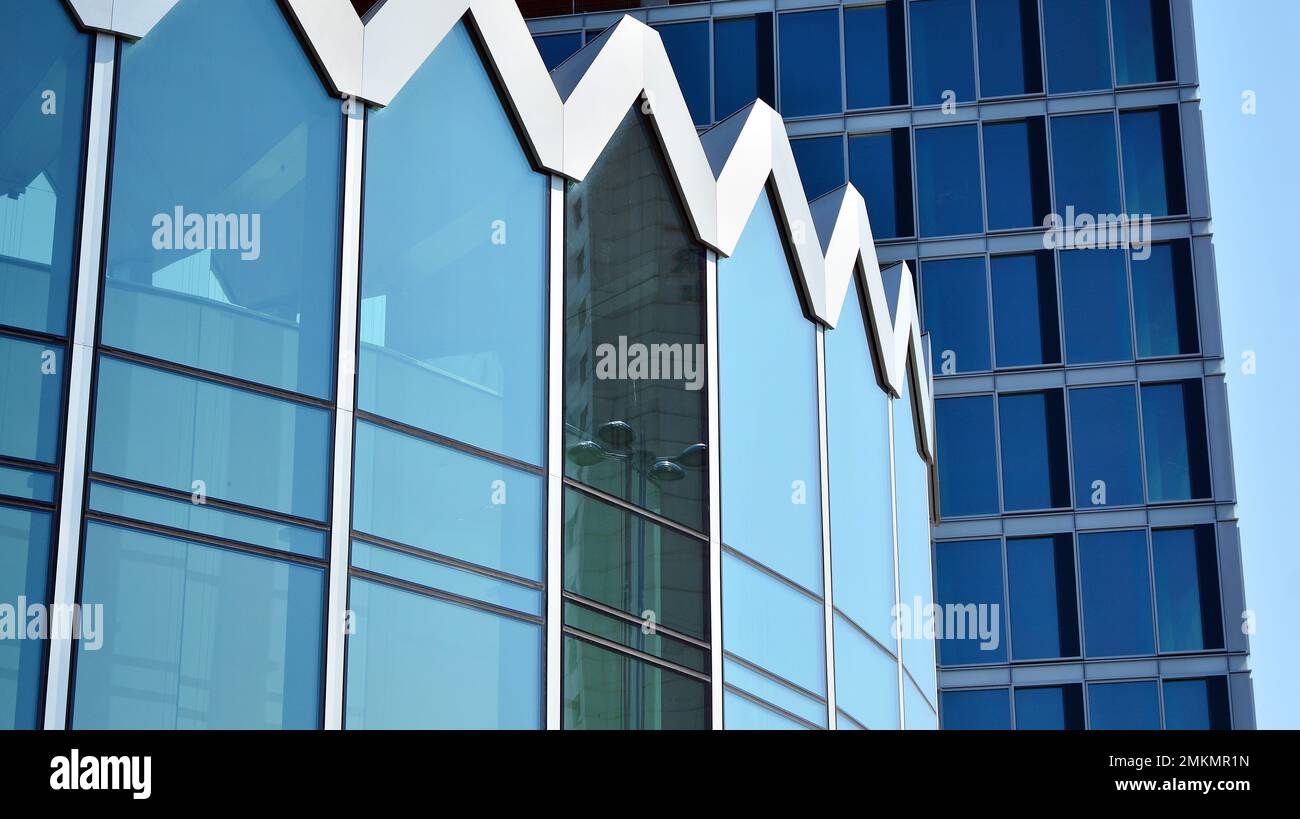 Abstract closeup of the glass-clad facade of a modern building covered ...