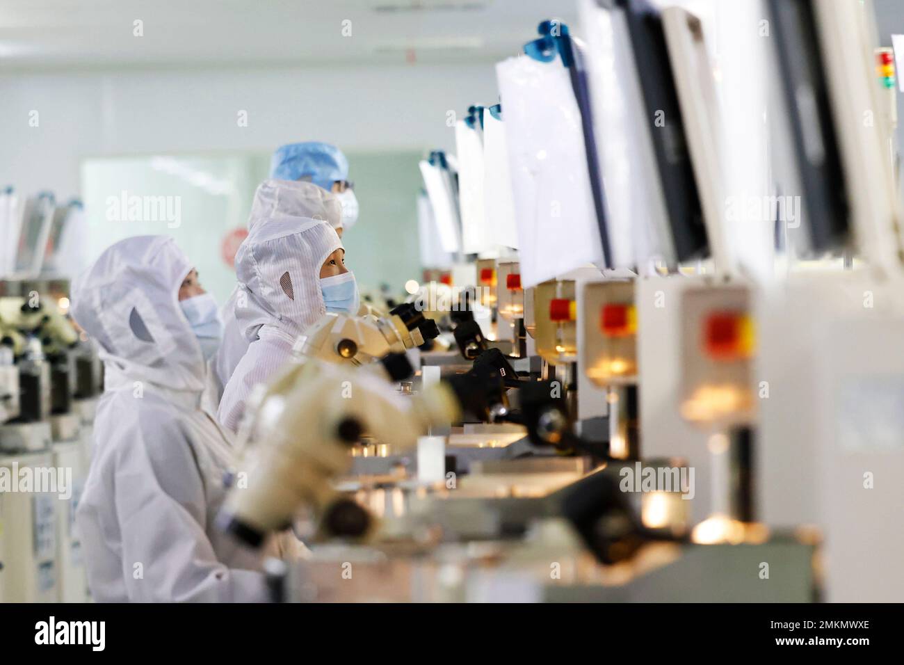 SUQIAN, CHINA - JANUARY 29, 2023 - Workers make electronic chips at a workshop in Suqian, East China's Jiangsu Province, Jan 29, 2023. Stock Photo