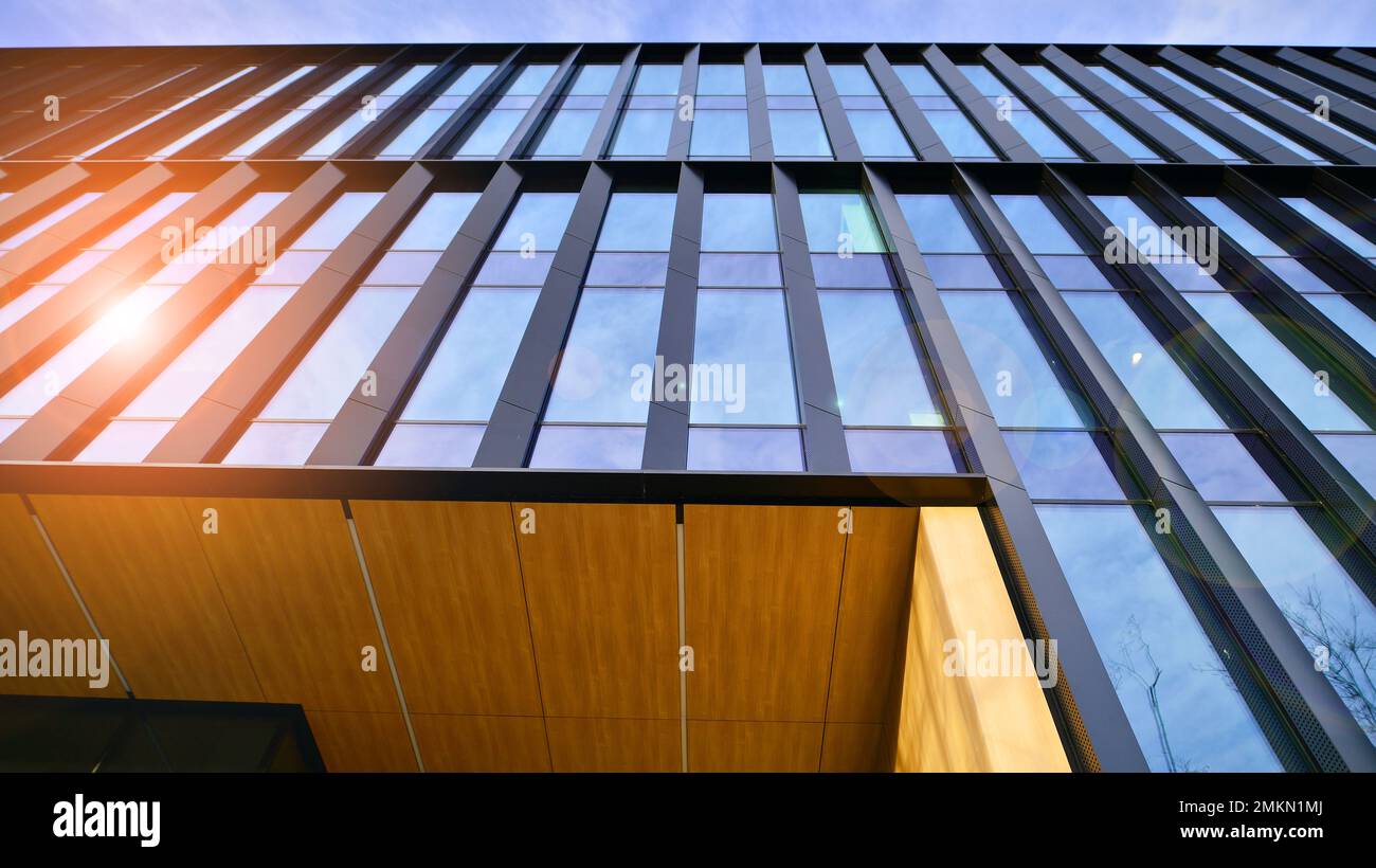 Abstract closeup of the glass-clad facade of a modern building covered ...