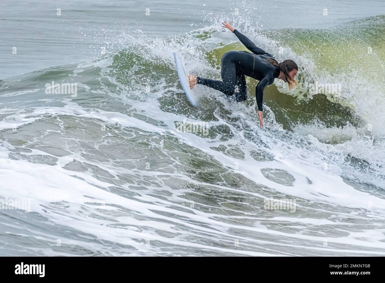 Surfer carving a wave at Jacksonville Beach on the Northeast Florida Coast. (USA) Stock Photo