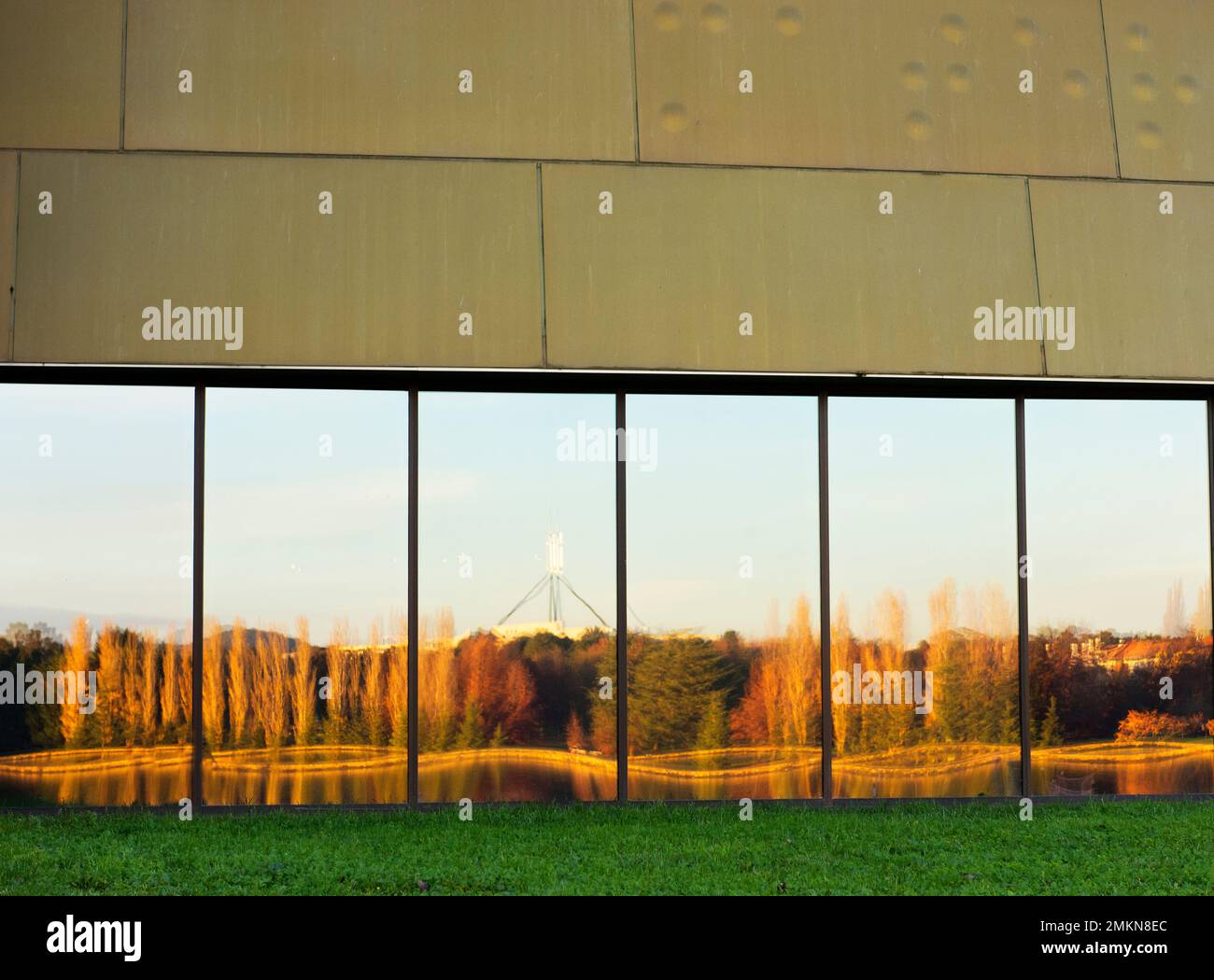 Stirling Park during autumn reflected in the windows of the National Museum. Stock Photo