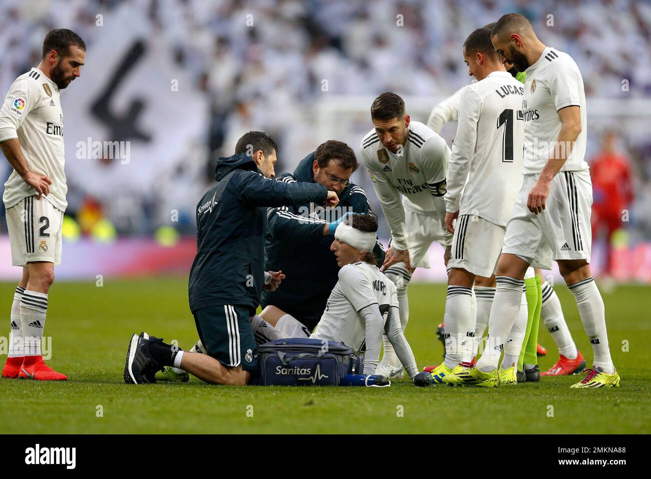 Real Madrid's Luka Modric, center, is attended by medical workers after ...
