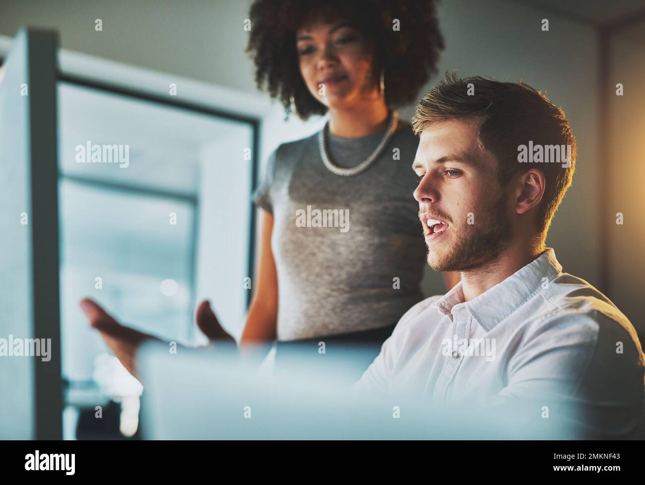 What do you think about the adjustments. two young designers working together on a computer in the office. Stock Photo