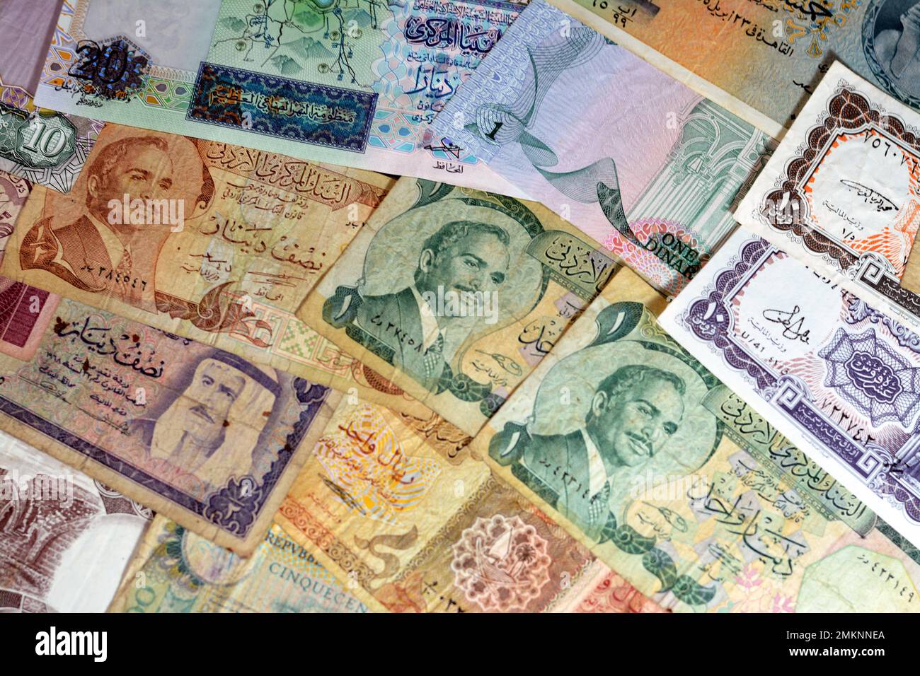 various old cash money banknotes from different countries of the world, stack of multiple currencies, pile of vintage retro bills of different origins Stock Photo