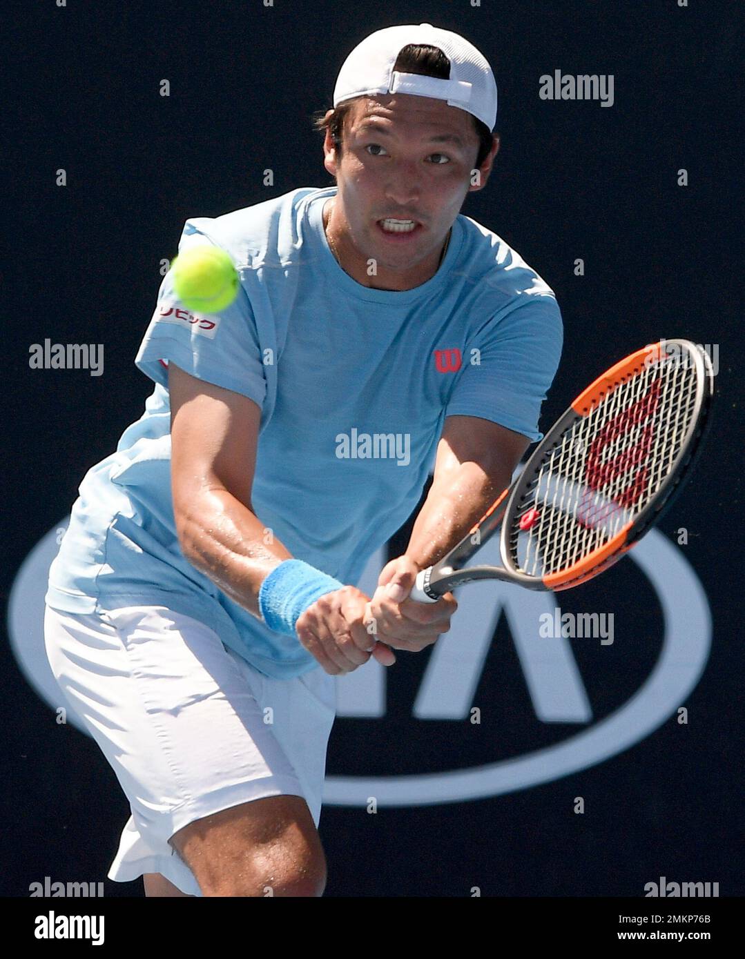 Japan's Tatsuma Ito hits a backhand return to Britain's Daniel Evans