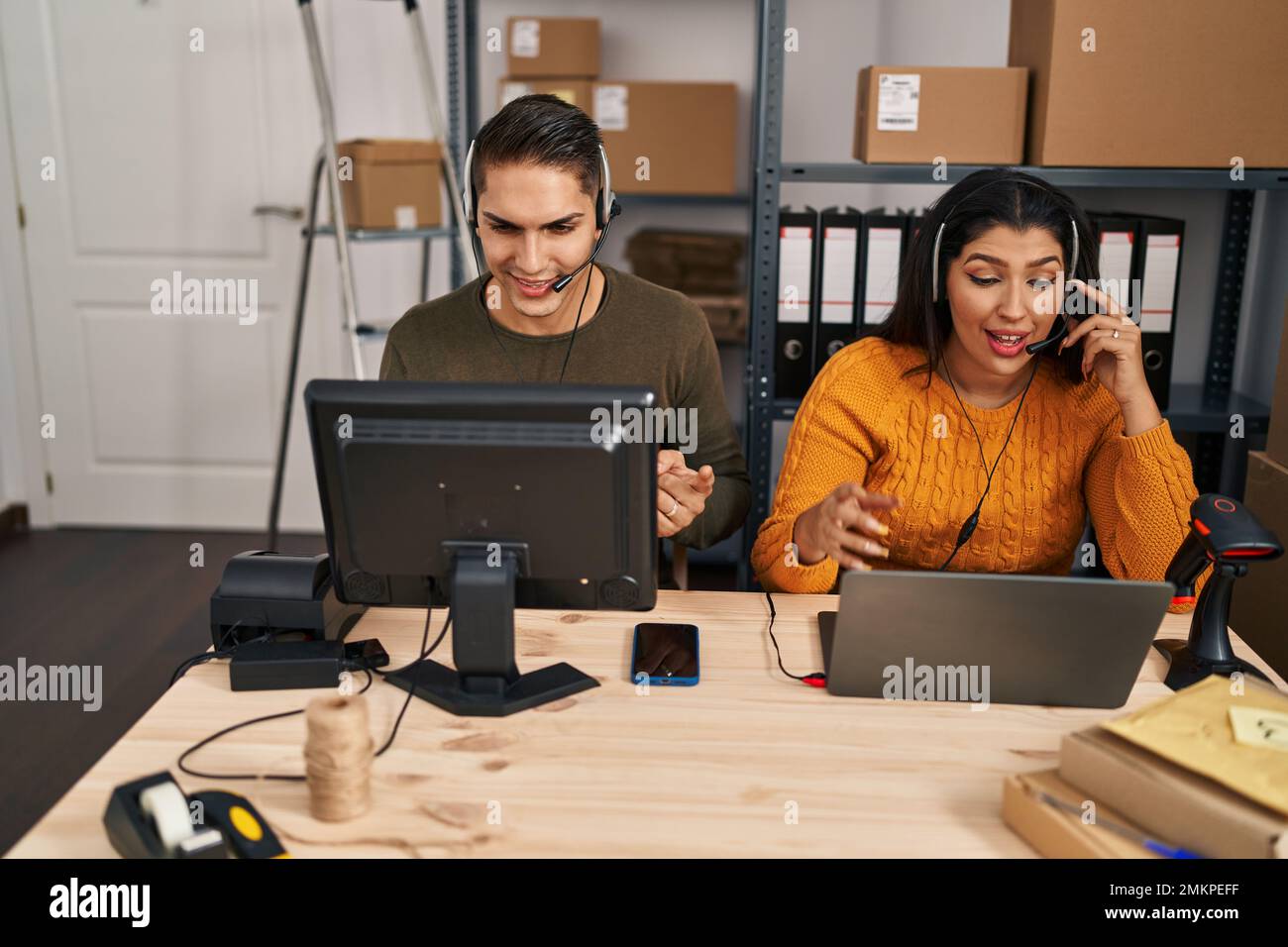 Man and woman call center agents working at office