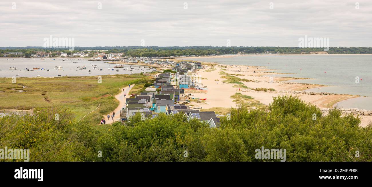 DORSET, UK - July 07, 2022. Beach huts on Hengistbury Head with Christchurch Harbour in the background. Panoramic landscape Stock Photo