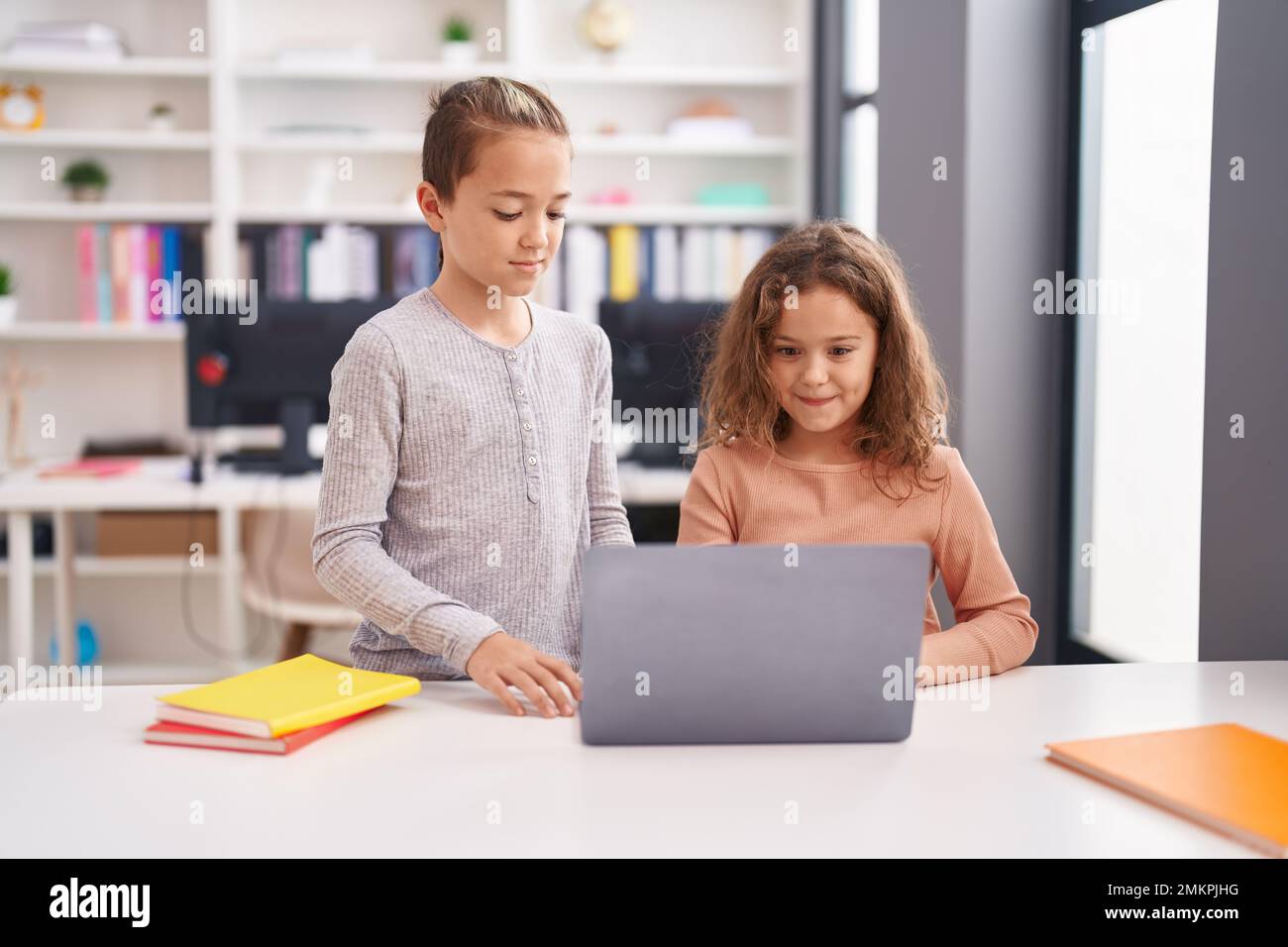 Two kids students using computer studying at classroom Stock Photo - Alamy