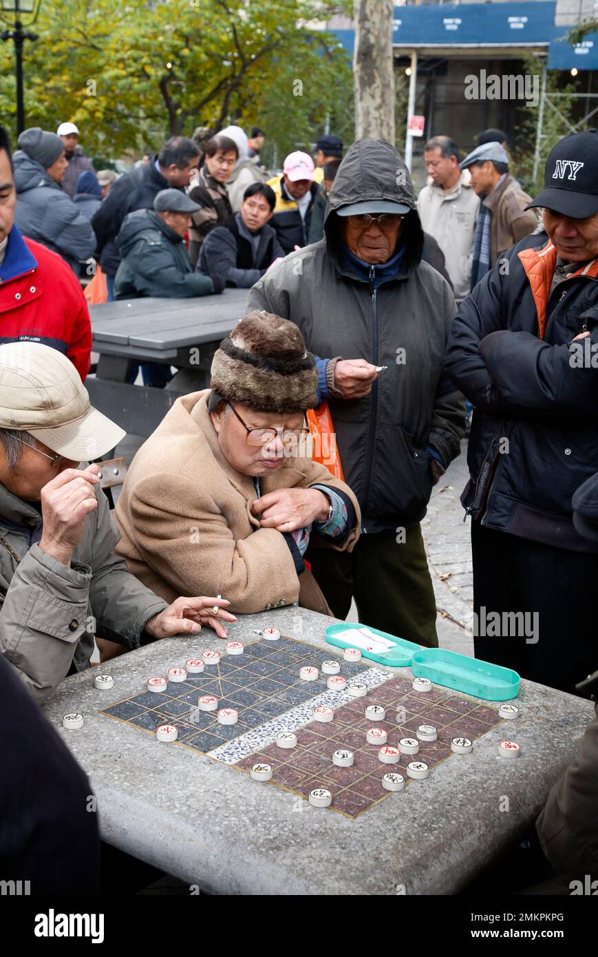 NEW YORK, USA - November 17, 2007. Men of Chinese ethnicity playing Xiangqi (Chinese chess) in a park in New York Stock Photo