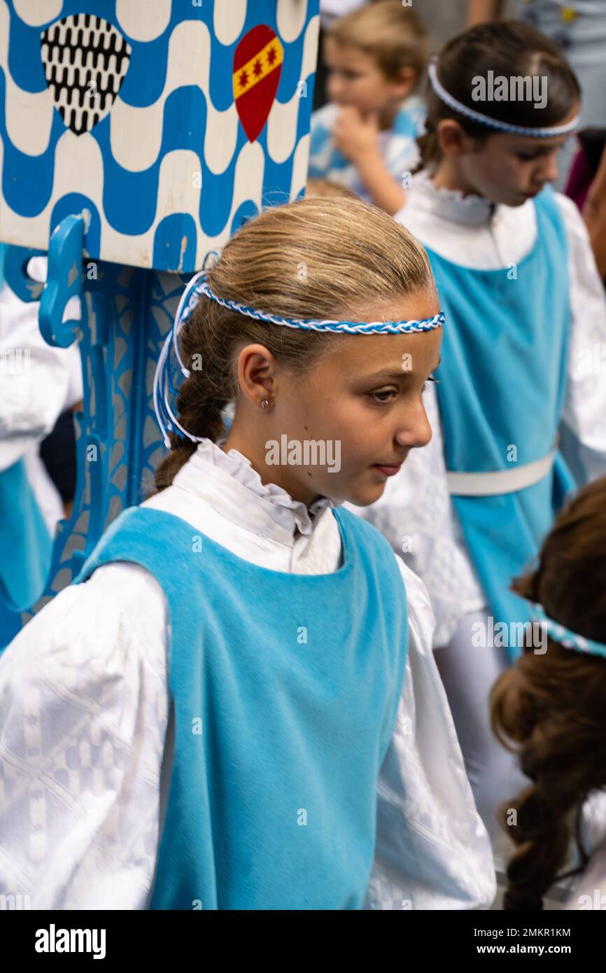 Siena, Italy - August 14 2022: Girl of the Contrada Capitana dell Onda at the Cero Votivo Procession at the Palio di Siena in Tuscany, Italy Stock Photo
