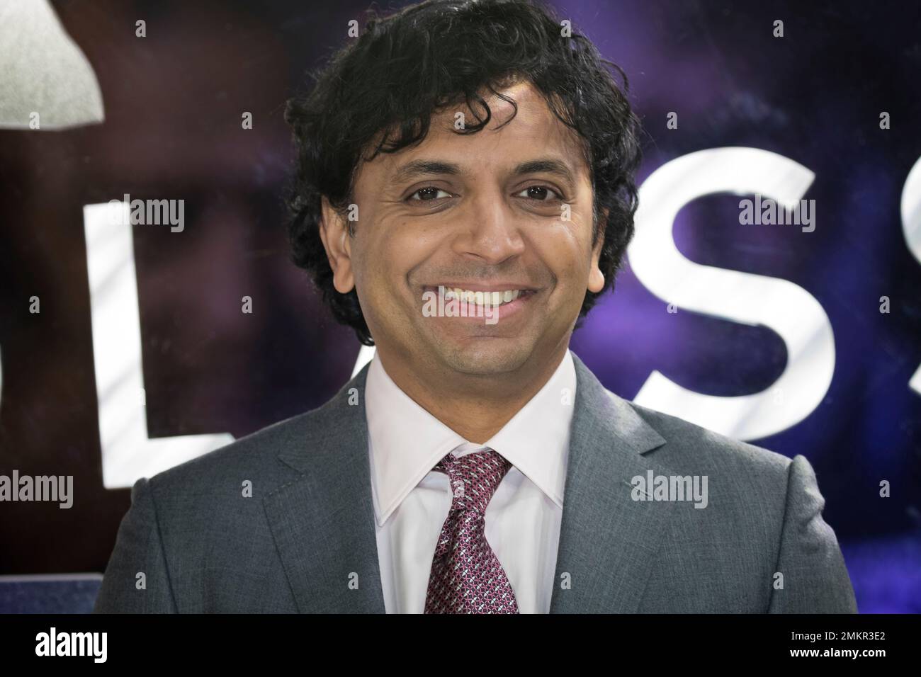 Director M. Night Shyamalan poses for photographers upon arrival at the
