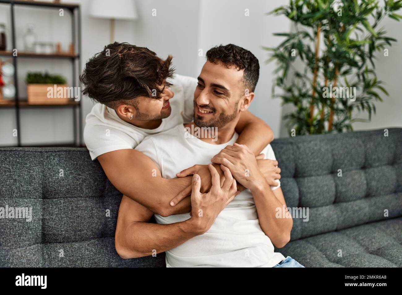 Two hispanic men couple smiling confident and hugging each other at ...