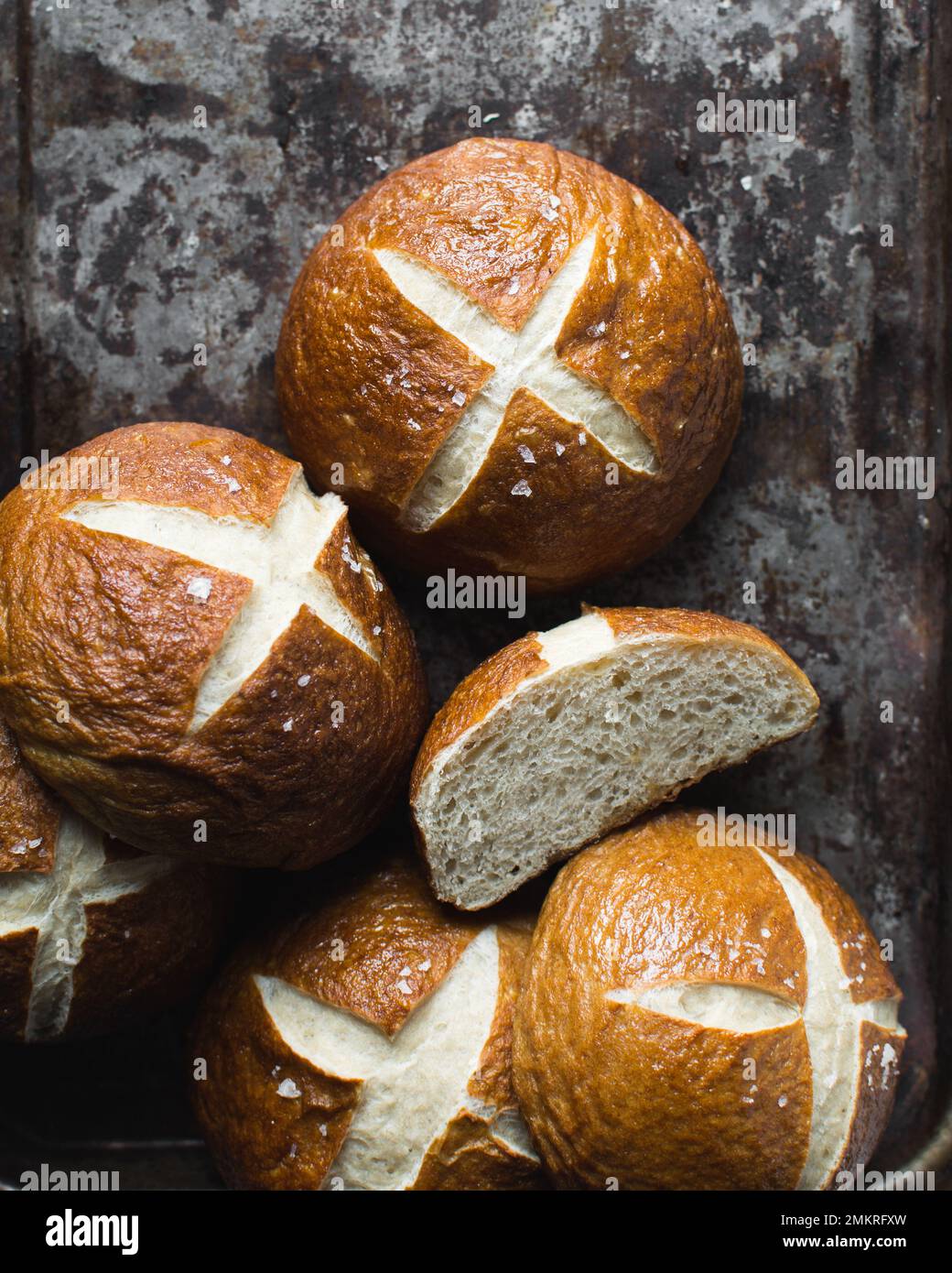 Pretzel buns on a baking sheet, German laugenbroetchen, lye buns on a