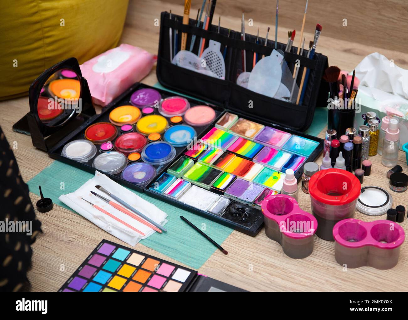 Colourful paint boxes and tubes with paints on a table. Paints and