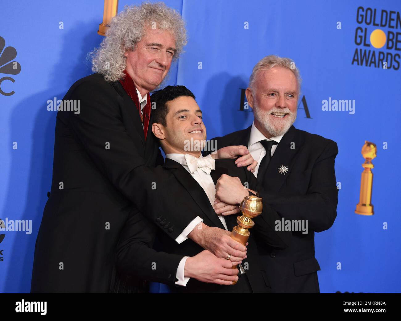 Brian May, left, and Roger Taylor, right, of Queen, and Rami Malek pose ...
