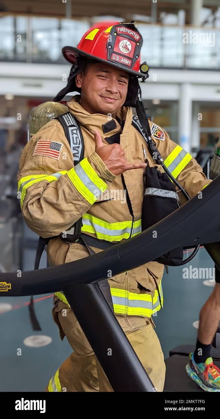 U.S. Army Sgt. Rene Gonzalez, a firefighter assigned to 23rd Ordnance Company, 18th Combat Sustainment Support Battalion, 16th Sustainment Brigade uses a stair climber machine while wearing firefighting equipment at the Tower Barracks Physical Fitness Center in Grafenwoehr, Germany, Sep. 11, 2022. Easterling and Soldiers from his company – an Army firefighting unit – each climbed 110 stories in memory of sacrifices made by firefighters responding to the September 11 terror attacks at the World Trade Center in New York City 21 years prior. Stock Photo