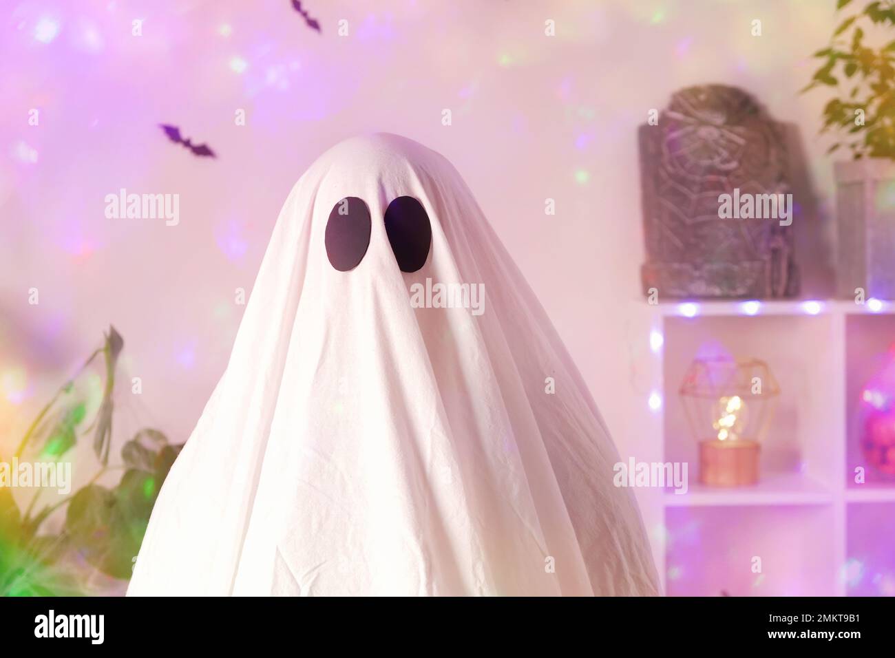 White ghost costume for Halloween party with neon lights in the