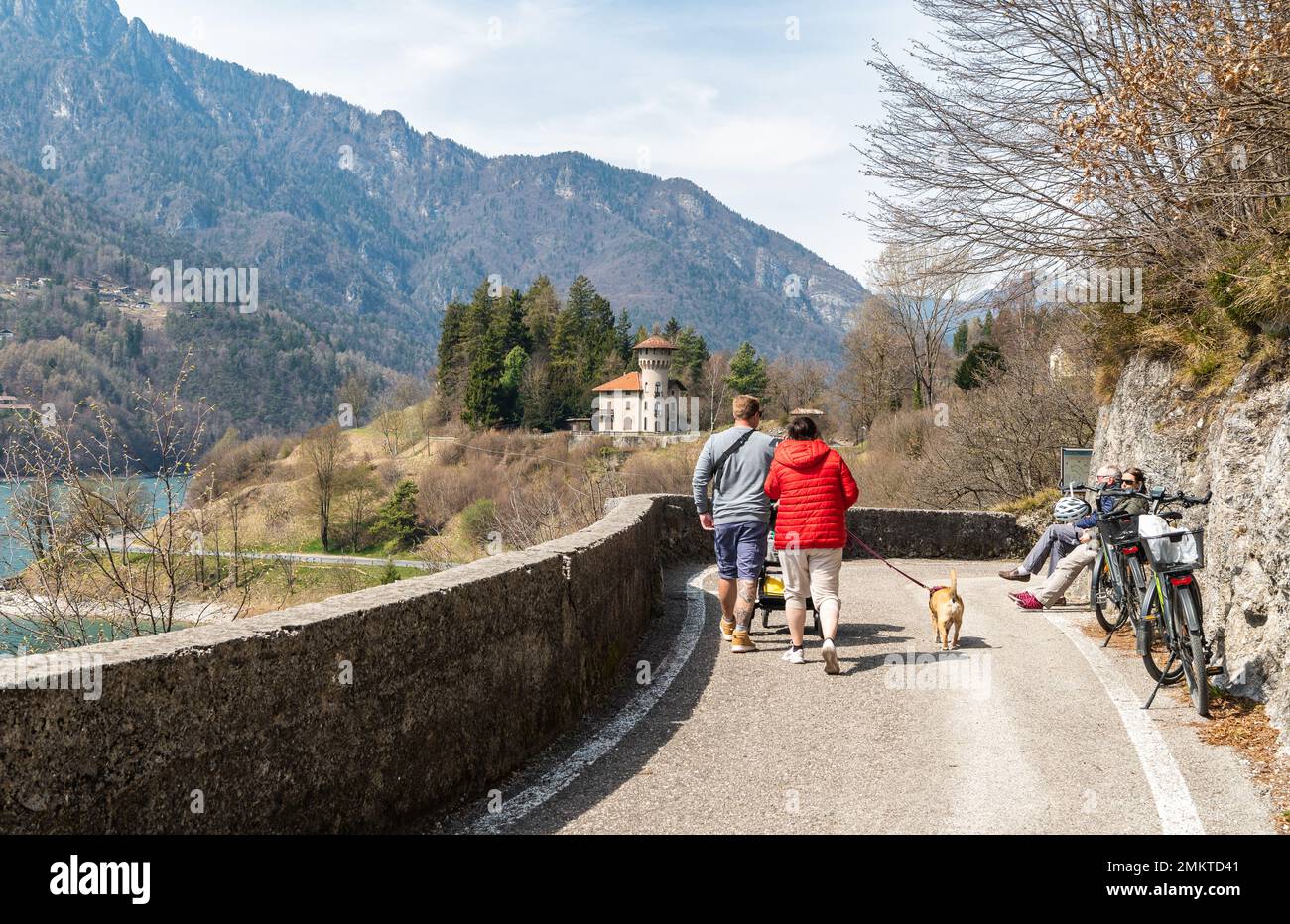 tourists walking on the promenade along the shore of Lake Ledro, with its four beaches and its villages (Piece, Mezzolago and Molina) - Trento provinc Stock Photo