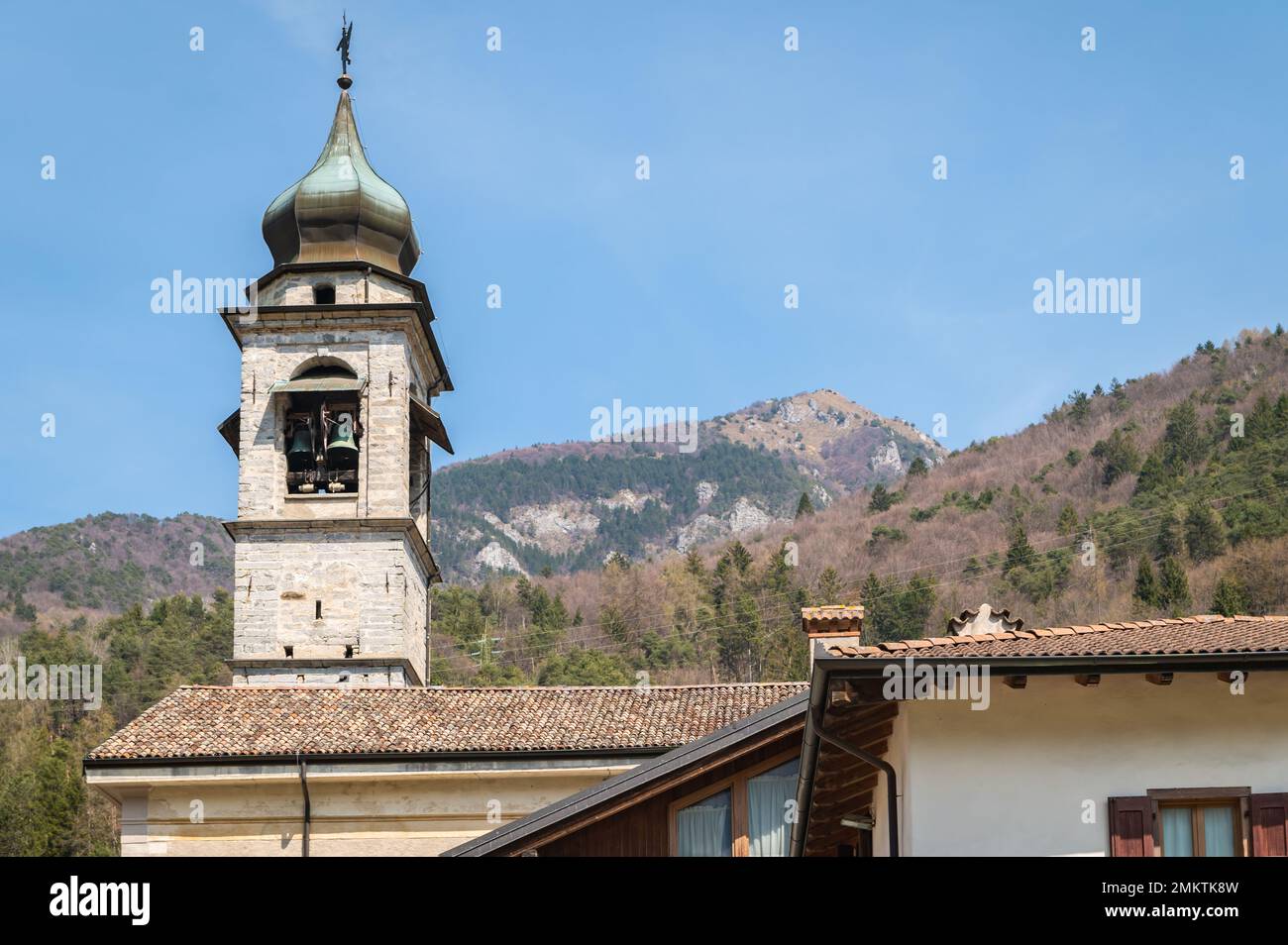 the brick bell tower of the Church of  the Annunciation (XIII century): is located in the center of the hamlet of Pieve di Ledro, Ledro Valley,Trento Stock Photo