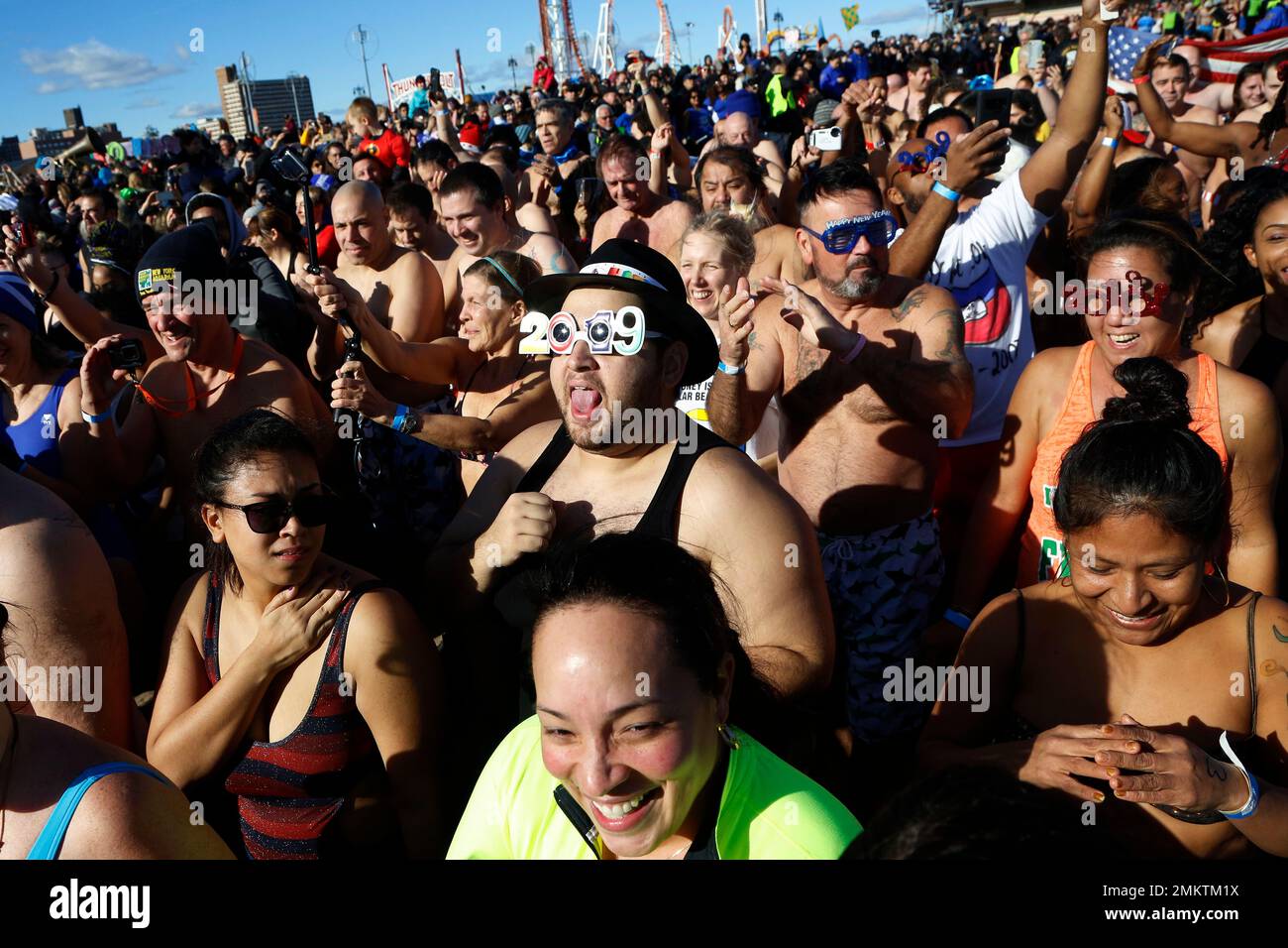 Swimmers crowd into the water in the Coney Island New Year's Day Polar ...