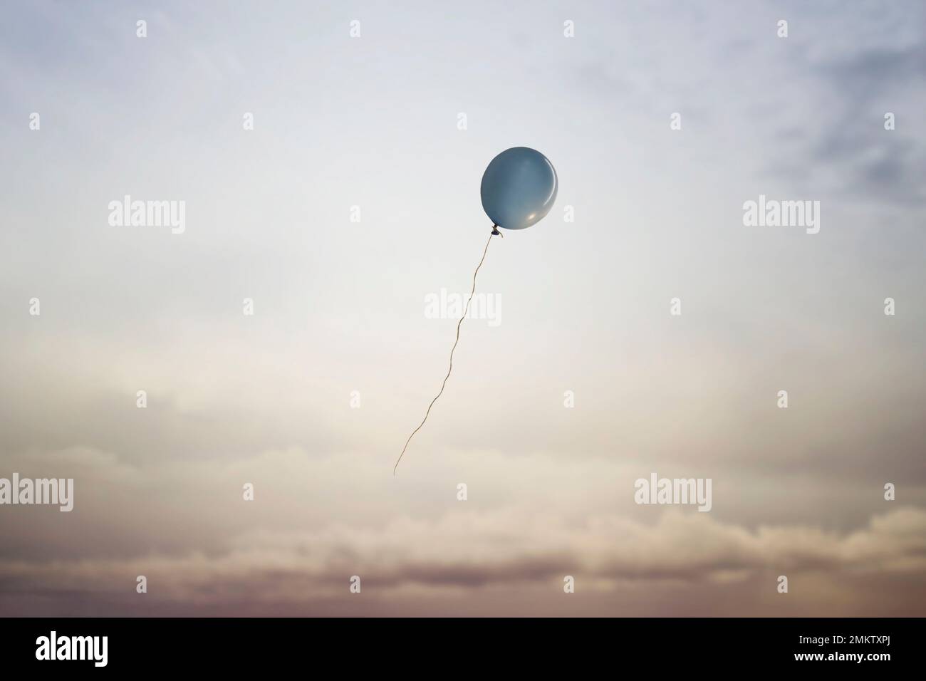 surreal travel of a balloon flying in the sky towards freedom, concept of lightness of the spirit of dreamers Stock Photo
