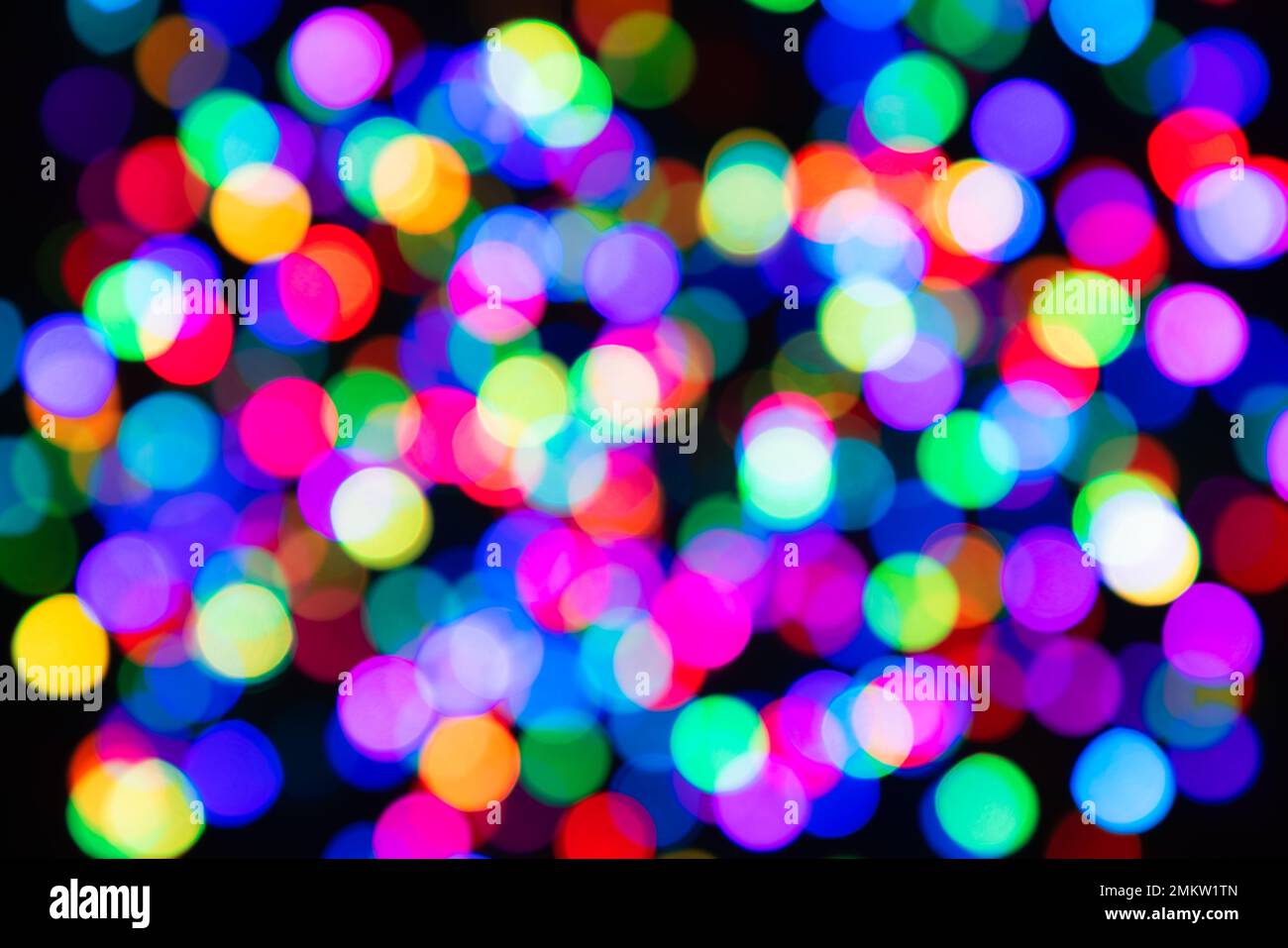 Colorful bokeh of light circles on a black background for the backdrop ...