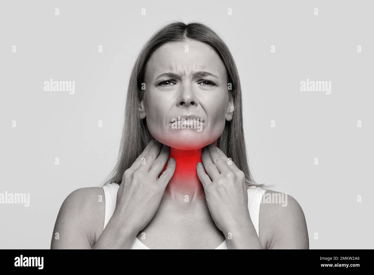 Woman suffering from sore throat, touching her neck Stock Photo Alamy