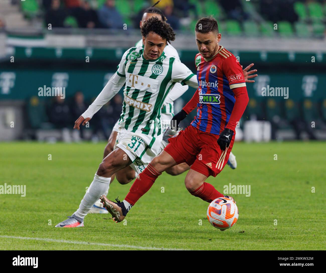 BUDAPEST, HUNGARY - MARCH 6: Claudiu Bumba of Kisvarda Master Good  challenges Henry Wingo of Ferencvarosi TC during the Hungarian OTP Bank  Liga match between Ferencvarosi TC and Kisvarda Master Good at