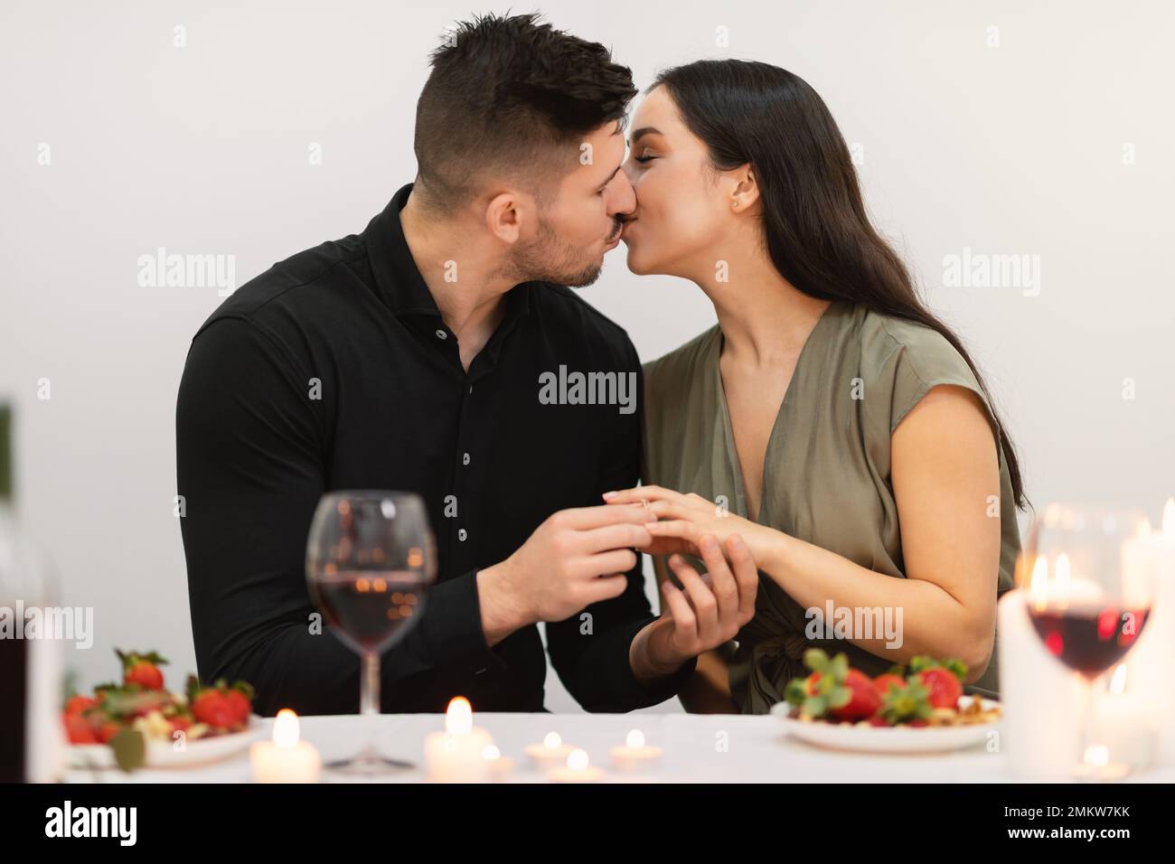 Loving couple kissing while have engagement celebration Stock Photo
