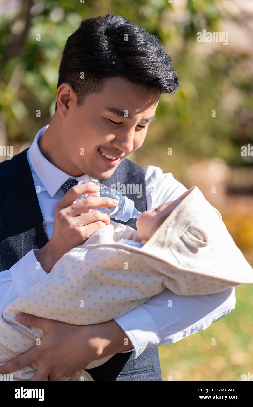 The young father holding a baby Stock Photo