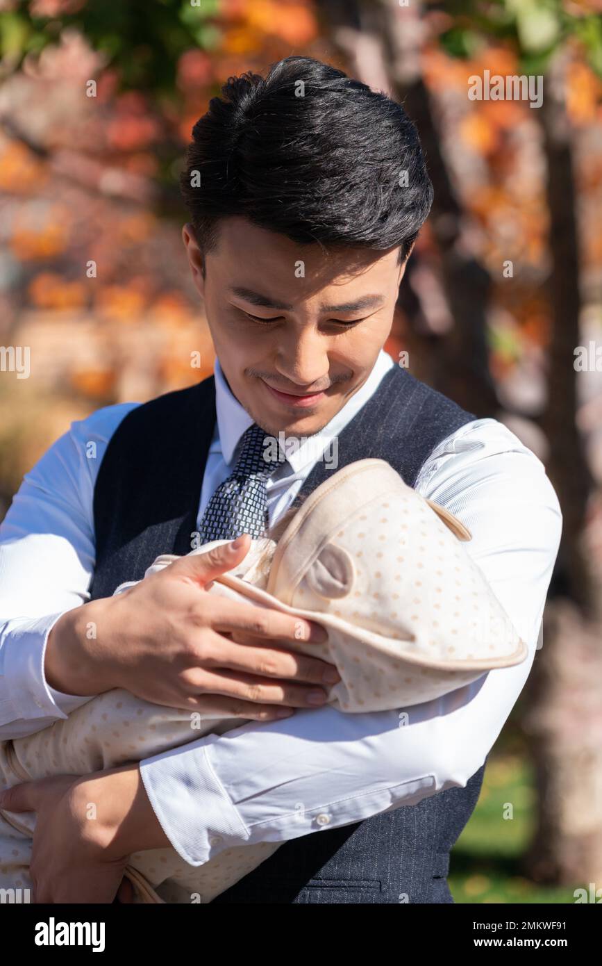 The young father holding a baby Stock Photo