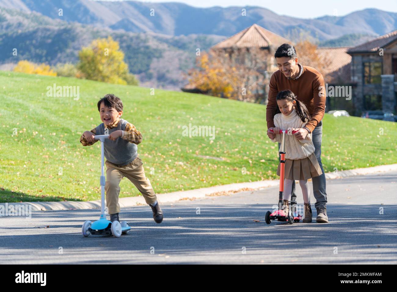 Father took the children to play in the scooter Stock Photo