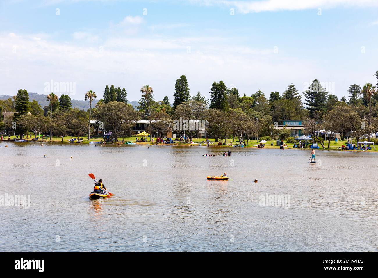 Narrabeen lake and lagoon on Sydney northern beaches in summer 2023, people enjoy kayaking on the water and swimming in the lake,Sydney,NSW,Australia Stock Photo