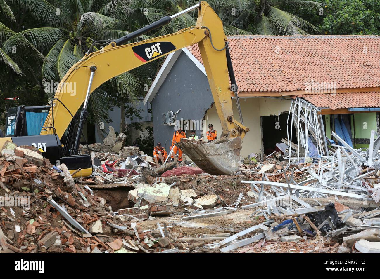 An excavator is used to clean up the debris following a tsunami in